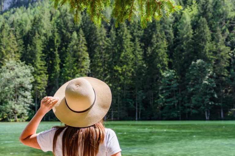 essentials of compassion focused therapy, a girl wearing a white hat looking at a lake with pine trees