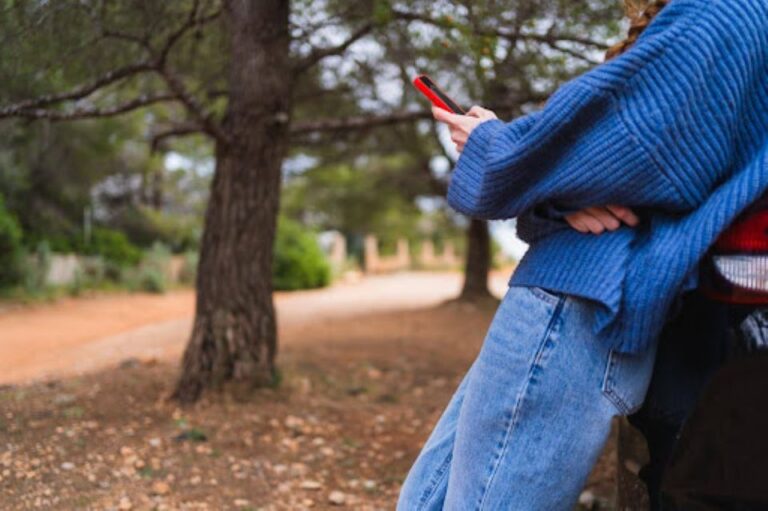 feelings of loneliness and isolation, woman scrolling on her phone