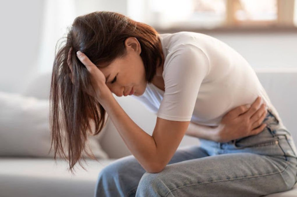 the gut-brain connection, woman suffering from stomach pain due to stress